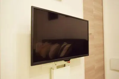 a flat screen tv hanging on a wall at Three Tokyo 102 in Tokyo
