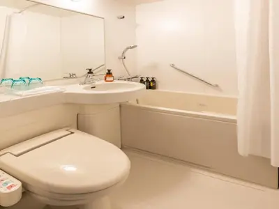 a bathroom with a toilet and a sink and a tub at Far East Village Hotel Tokyo Ariake in Tokyo