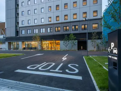 an empty parking lot in front of a building with the word aids at Far East Village Hotel Tokyo Ariake in Tokyo