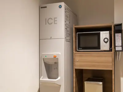 a white refrigerator next to a microwave next to a counter at Far East Village Hotel Tokyo Ariake in Tokyo