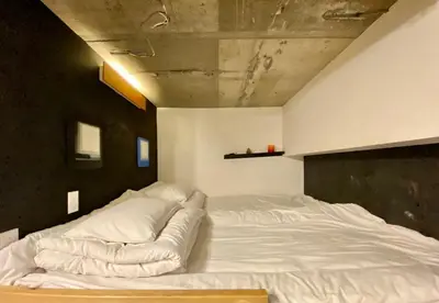 a large white bed in a room with a ceiling at Shibuya Center Mansion#2DK in Tokyo