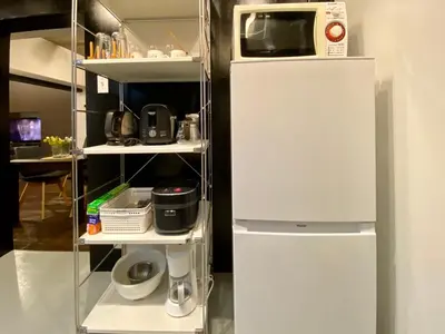 a refrigerator with a microwave on a shelf at Shibuya Center Mansion#2DK in Tokyo