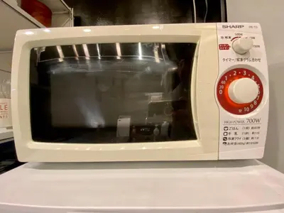 a white microwave oven sitting on top of a counter at Shibuya Center Mansion#2DK in Tokyo