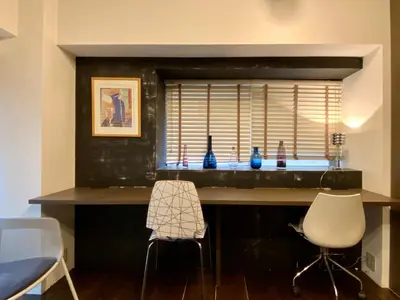 a kitchen with a table and two chairs and a window at Shibuya Center Mansion#2DK in Tokyo