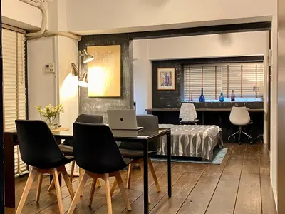 a dining room with a table with a laptop on it at Shibuya Center Mansion#2DK in Tokyo