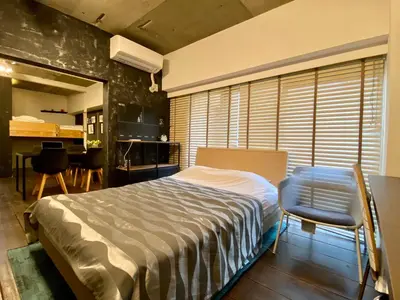 a bedroom with a bed and a table and chairs at Shibuya Center Mansion#2DK in Tokyo