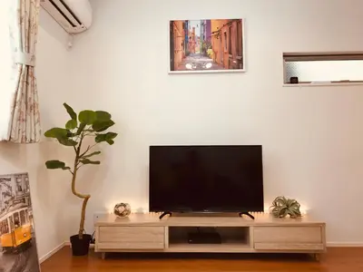 a flat screen tv sitting on a entertainment center in a living room at Alo BnB 5 - Near NIPPORI, SENDAGI, YANAKA GINZA, UENO - Self check-in in Tokyo