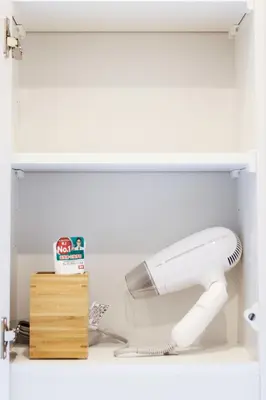 a white hairdryer on a shelf in a bathroom at Alo BnB 5 - Near NIPPORI, SENDAGI, YANAKA GINZA, UENO - Self check-in in Tokyo