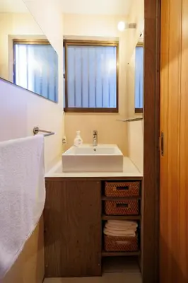 a bathroom with a sink and a mirror at SMILE STAY Shinnakano in Tokyo