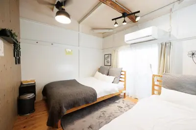 a bedroom with two beds and a window at SMILE STAY Shinnakano in Tokyo