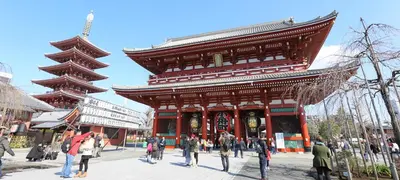 a group of people standing in front of a large building at Sakura Cross Hotel Ueno Okachimachi in Tokyo