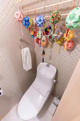 a bathroom with a toilet with umbrellas on the wall at CuteFamilyHouse! 8min Shinjuku 5minJR 3minSubway Cozy,Quiet KidsFree Under6yrs in Tokyo