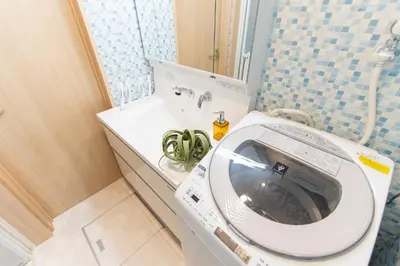 a bathroom with a washing machine and a sink at CuteFamilyHouse! 8min Shinjuku 5minJR 3minSubway Cozy,Quiet KidsFree Under6yrs in Tokyo