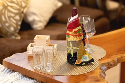 a bottle of wine sitting on a table with glasses at CuteFamilyHouse! 8min Shinjuku 5minJR 3minSubway Cozy,Quiet KidsFree Under6yrs in Tokyo