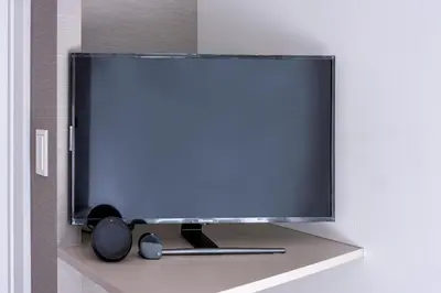 a flat screen tv hanging on a wall at &AND HOSTEL MINAMISENJU in Tokyo