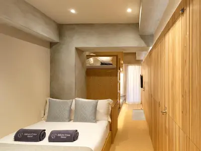 a bedroom with a bed with two towels on it at Sakura Cross Hotel Tokyo Kayabacho in Tokyo