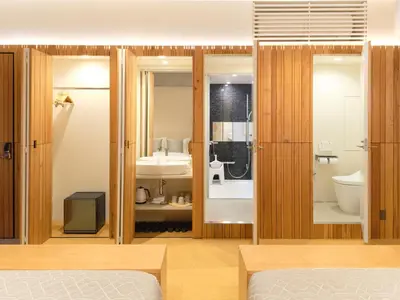 a bedroom with a bed and a bathroom at Sakura Cross Hotel Tokyo Kayabacho in Tokyo