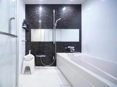 a bathroom with a white tub and a toilet at Sakura Cross Hotel Tokyo Kayabacho in Tokyo