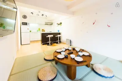 a living room with a table and some chairs at Shibuya Lions Mansion#1DK in Tokyo