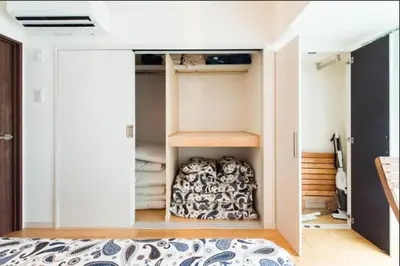 a small bedroom with a bed and a closet at Shibuya Lions Mansion#1DK in Tokyo