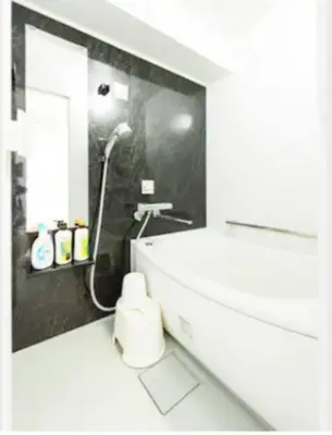 a white bathroom with a shower and a sink at Shibuya Lions Mansion#1DK in Tokyo