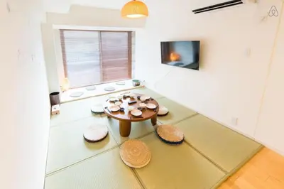 a living room with a table and some stools at Shibuya Lions Mansion#1DK in Tokyo