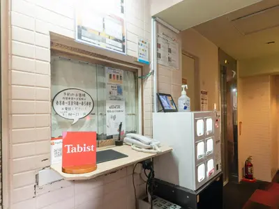 a restaurant with a counter with a phone in a window at Tabist Hotel Florida Ikebukuro in Tokyo