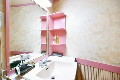 a bathroom with a sink and a large mirror at Tabist Hotel Florida Ikebukuro in Tokyo
