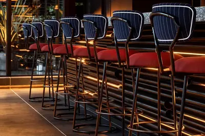 a row of chairs lined up at a bar at THE LIVELY TOKYO AZABUJUBAN in Tokyo