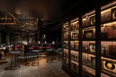 a bar with stools in a room with a lot of cabinets at THE LIVELY TOKYO AZABUJUBAN in Tokyo