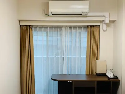 a room with a window with a desk and a heater at Le Tour Hotel Akihabara Ekimae \u697d\u9014\u30db\u30c6\u30eb\u79cb\u8449\u539f\u99c5\u524d\u5e97 in Tokyo