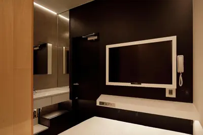 a black bathroom with a tv on a black wall at hotel min \u5927\u4eba\u5c02\u7528 in Tokyo