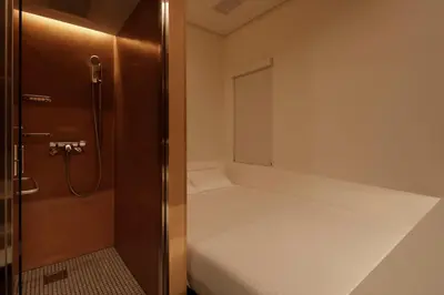 a small room with a bed and a window at hotel min \u5927\u4eba\u5c02\u7528 in Tokyo