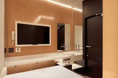a bathroom with a sink and a tv on the wall at hotel min \u5927\u4eba\u5c02\u7528 in Tokyo