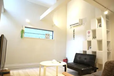 a living room with a black leather chair and a table at Building A101 / Vacation STAY 1274 in Tokyo