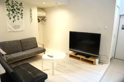 a living room with a couch and a flat screen tv at Building A101 / Vacation STAY 1274 in Tokyo