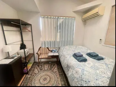 a small bedroom with a bed and a chair at Private room in new House in Tokyo