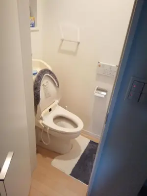 a bathroom with a toilet with its seat up at Private room in new House in Tokyo