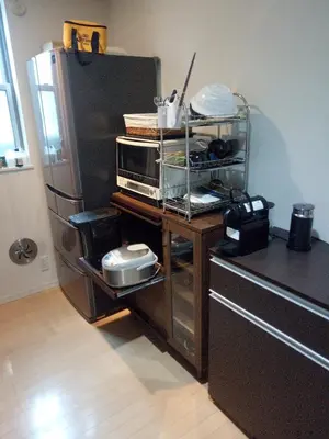 a kitchen with a counter with a microwave and a refrigerator at Private room in new House in Tokyo