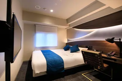 a hotel room with a bed and a desk at Quintessa Hotel Tokyo Ginza in Tokyo