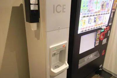 a machine with an ice dispenser next to a wall at Quintessa Hotel Tokyo Ginza in Tokyo