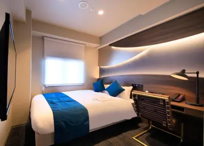 a hotel room with a bed and a desk at Quintessa Hotel Tokyo Ginza in Tokyo