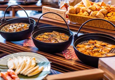 a buffet with three bowls of food and bread at APA Hotel & Resort Ryogoku Ekimae Tower in Tokyo