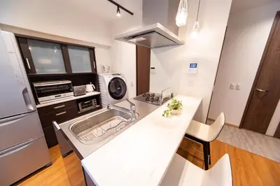a kitchen with a sink and a microwave at NIYS apartments 03 type in Tokyo