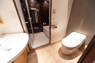 a bathroom with a shower and a toilet and a sink at NIYS apartments 03 type in Tokyo