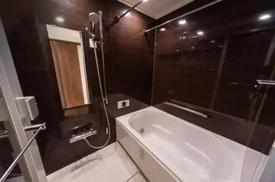 a bathroom with a bath tub and a shower at NIYS apartments 03 type in Tokyo