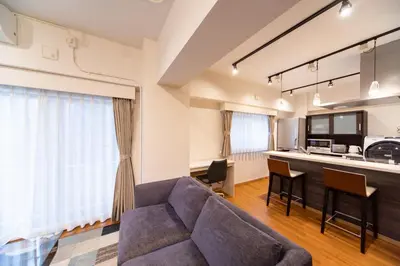 a living room with a couch and a kitchen at NIYS apartments 03 type in Tokyo