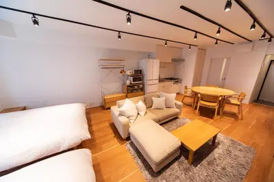 a living room with a couch and a table at NIYS apartments 08 type in Tokyo