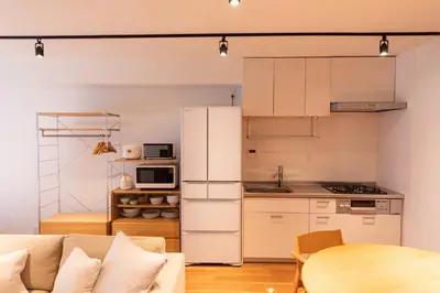 a kitchen with a couch and a table in a room at NIYS apartments 08 type in Tokyo