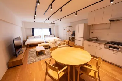a kitchen and living room with a table and a couch at NIYS apartments 08 type in Tokyo